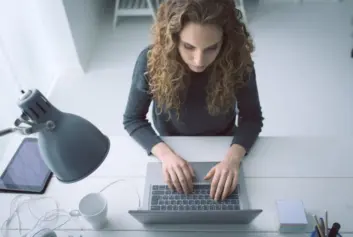 woman typing on laptop