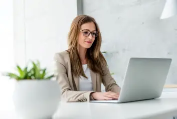 businesswoman typing on laptop