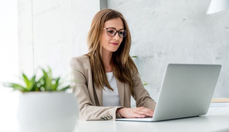 businesswoman typing on laptop