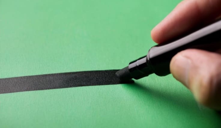 Hand drawing a line with marker.