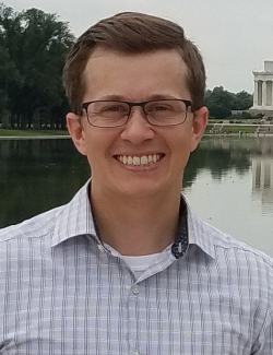 A headshot of Adam Daugeau.